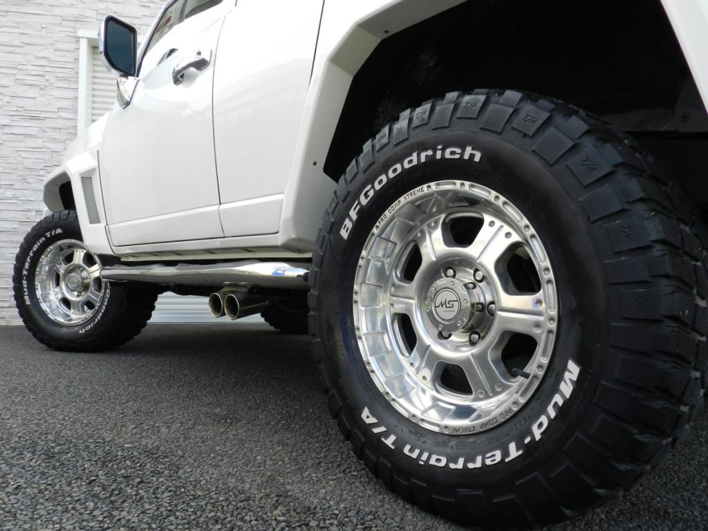 FJクルーザーのアルミホイールとBFGoodrichタイヤ、マフラーを接写した写真
