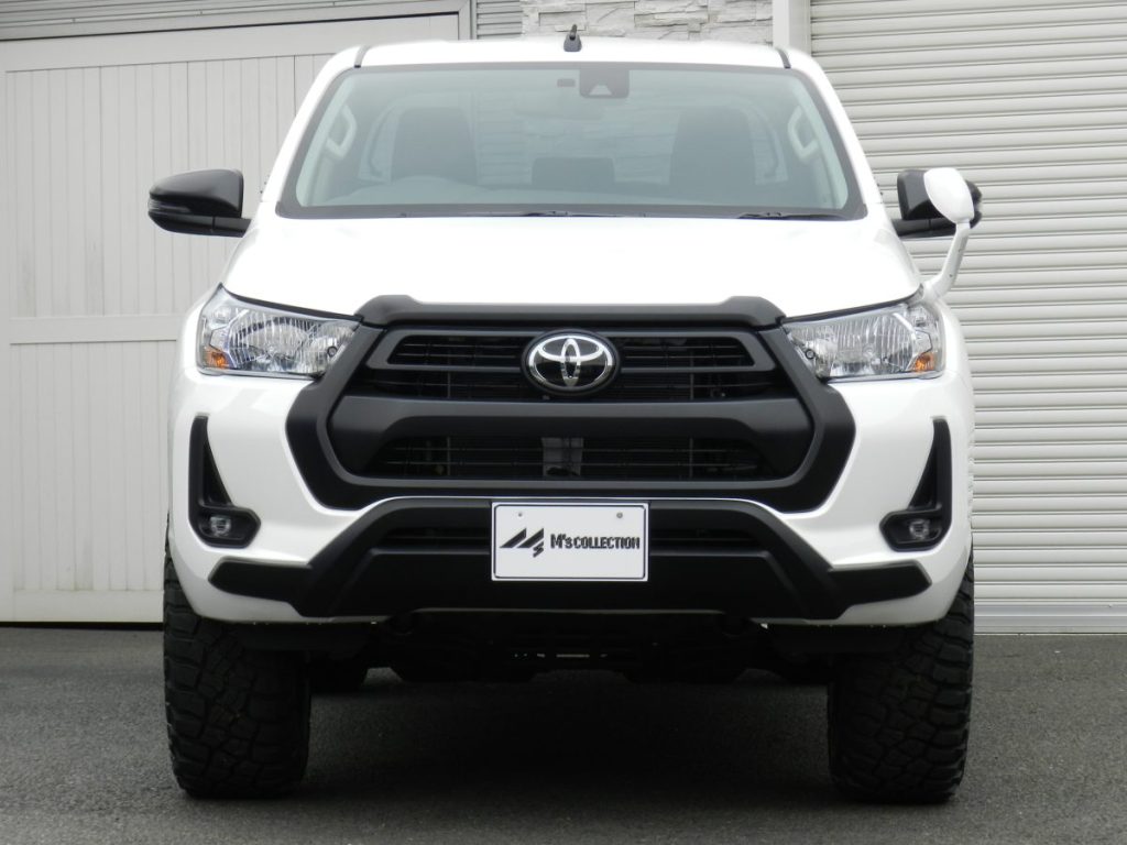 TOYOTA HILUX X GUN125 白 フロント正面からの外観、リフトアップカスタムと太いタイヤが分かる様子