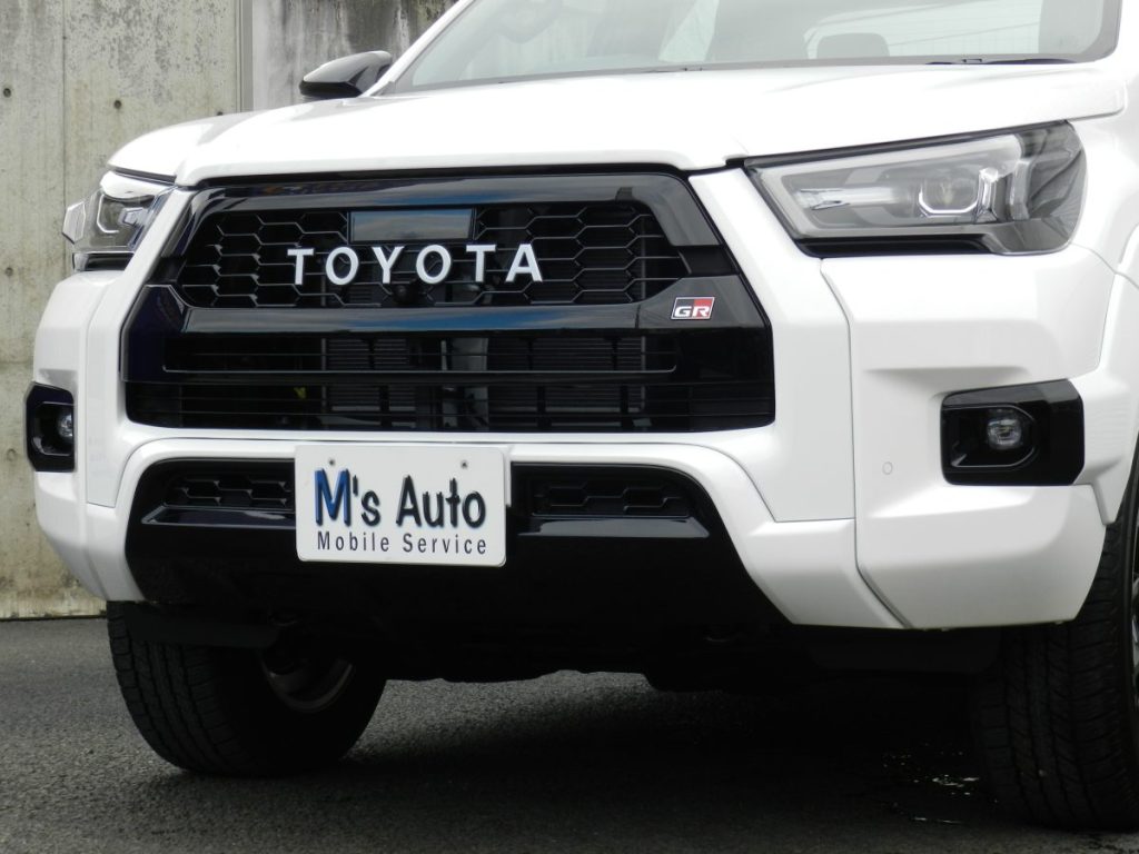 トヨタ ハイラックス GRスポーツ TOYOTA文字グリルとGRバッジのクローズアップ
